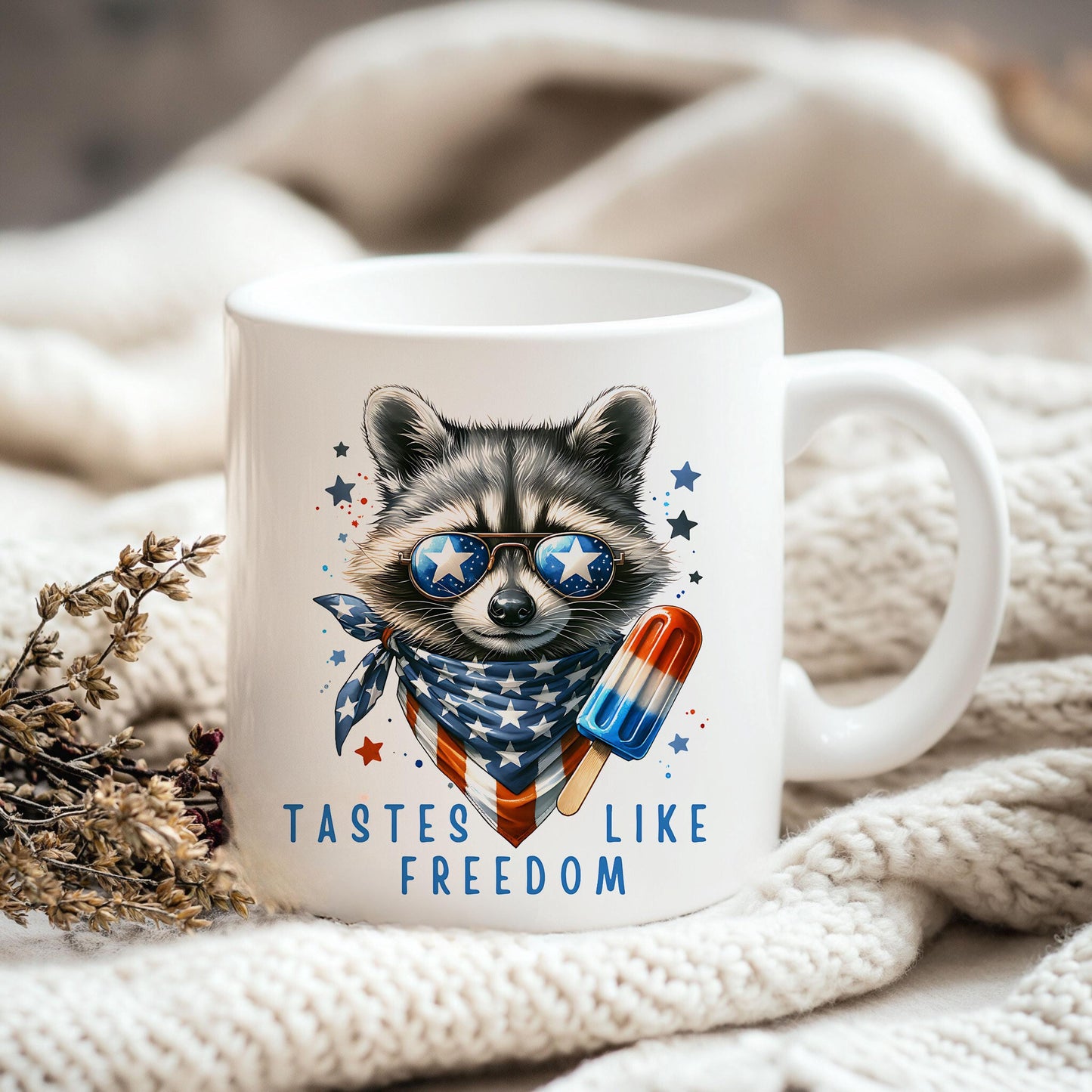 a raccoon wearing sunglasses and a scarf is sitting on a blanket