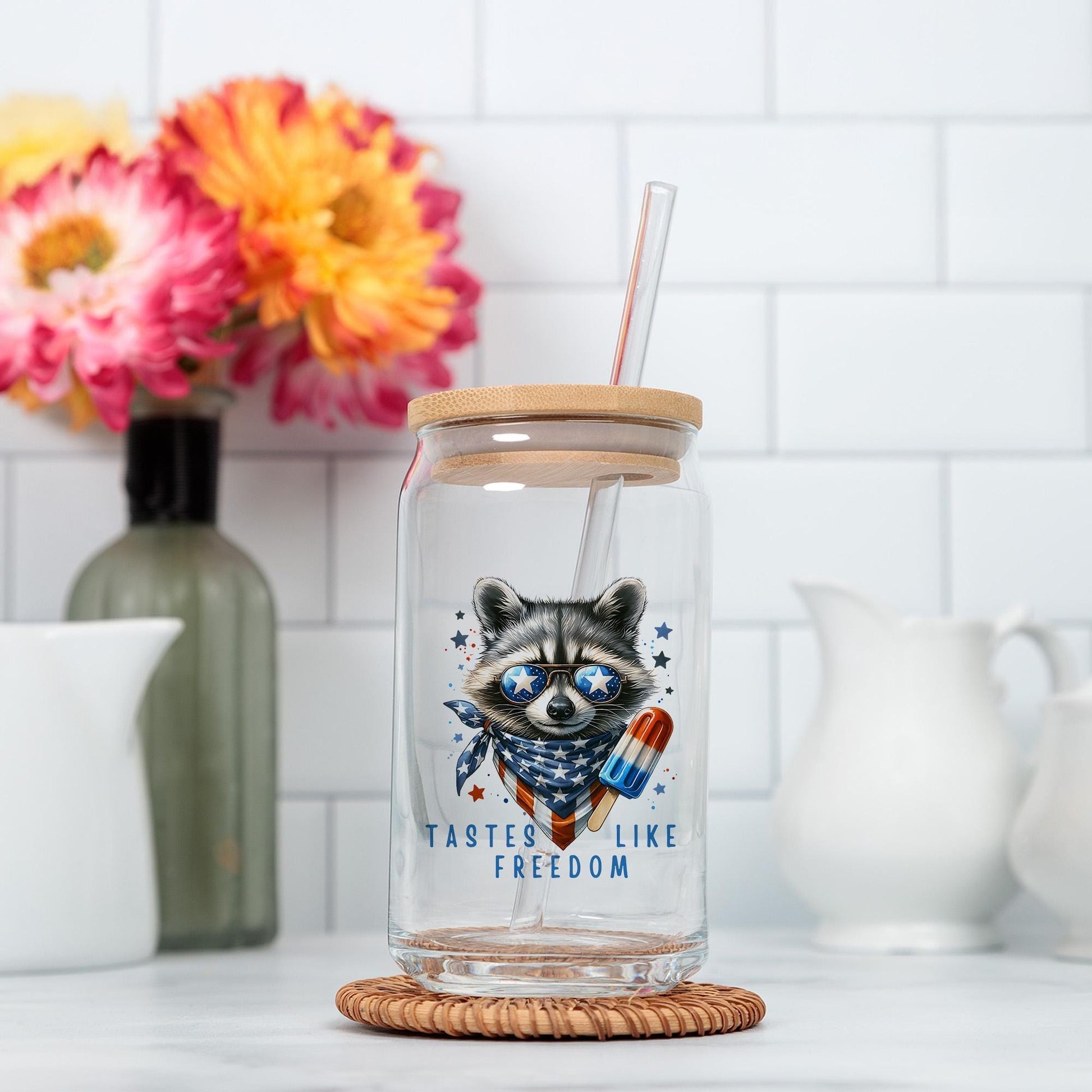 a glass jar with a raccoon on it and a straw in it