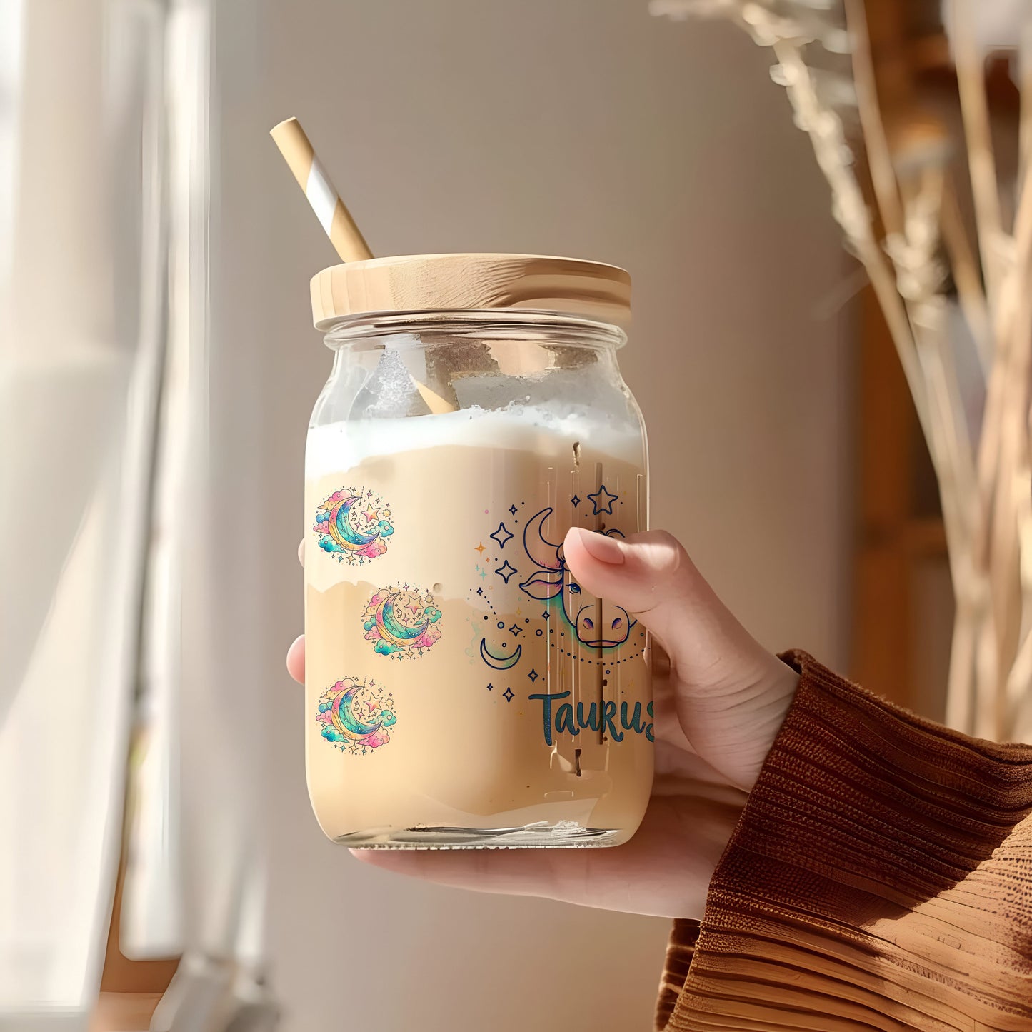 a person holding a jar with a straw in it
