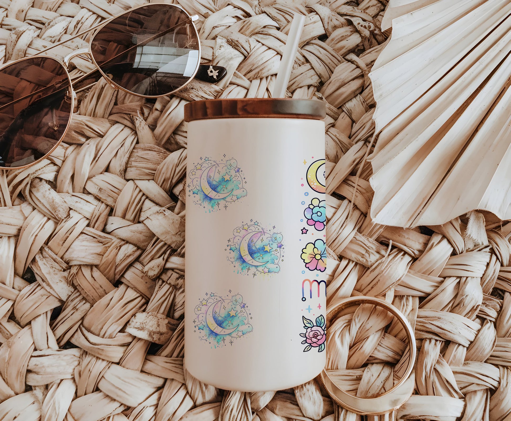 a white coffee cup sitting on top of a table next to sunglasses