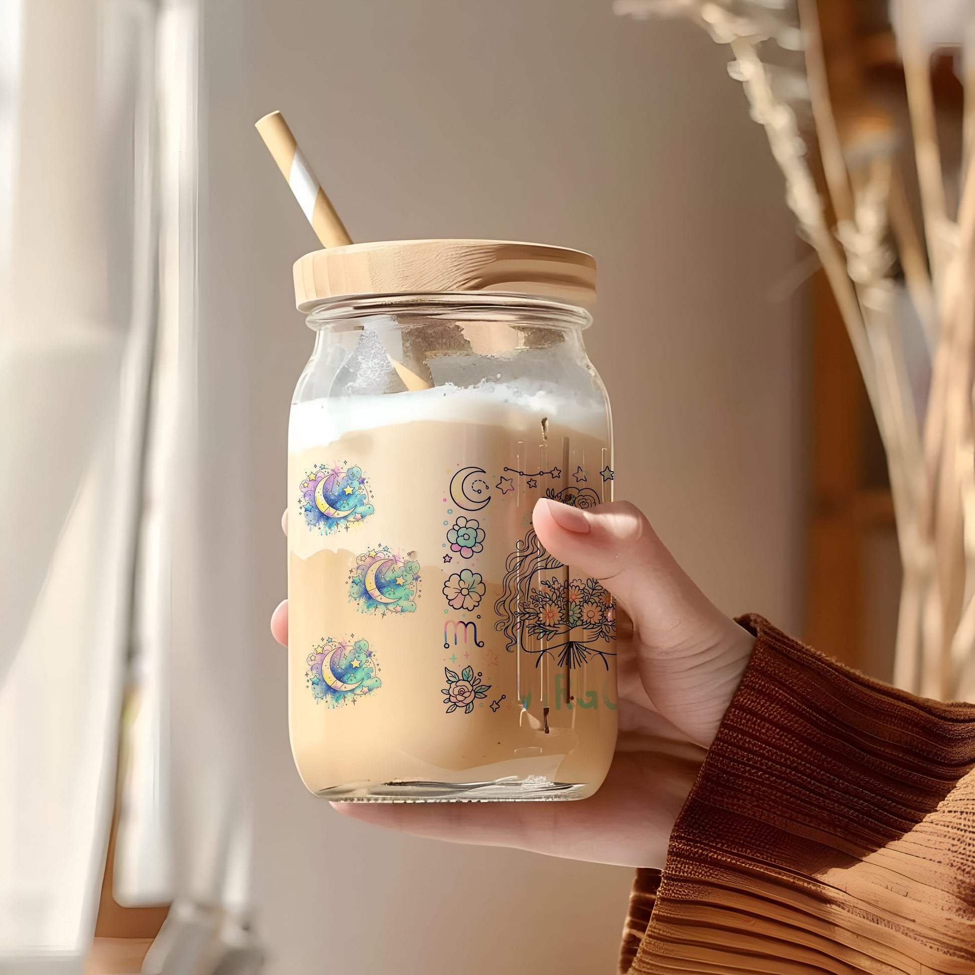 a person holding a jar with a straw in it